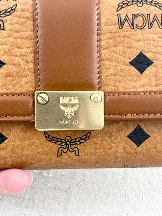 MCM long wallet crafted in iconic cognac visetos coated canvas with logo print and smooth leather accents
