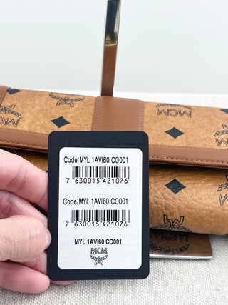 MCM long wallet crafted in iconic cognac visetos coated canvas with logo print and smooth leather accents