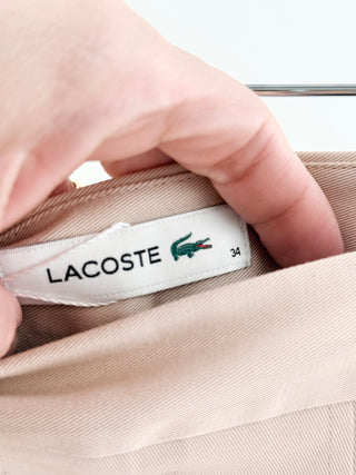 Lacoste chic skirt features structured box pleats that create an A-line silhouette in smooth cotton fabric, 34