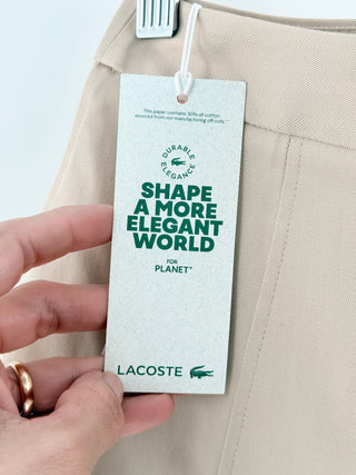 Lacoste chic skirt features structured box pleats that create an A-line silhouette in smooth cotton fabric, 34
