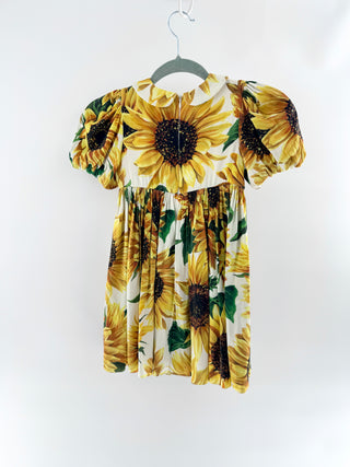 Dolce and Gabbana cotton dress featuring signature sunflower print, puff sleeves, peter pan collar, decorative button front, 6A