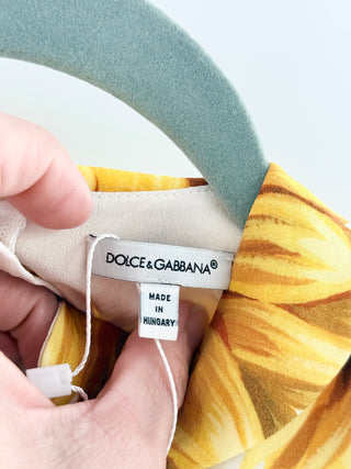 Dolce and Gabbana cotton dress featuring signature sunflower print, puff sleeves, peter pan collar, decorative button front, 6A