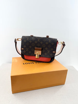 Louis Vuitton Vaugirard bag in iconic monogram coated canvas with striking coquelicot red leather trim, designed with structured flap and finished with signature S-lock closure