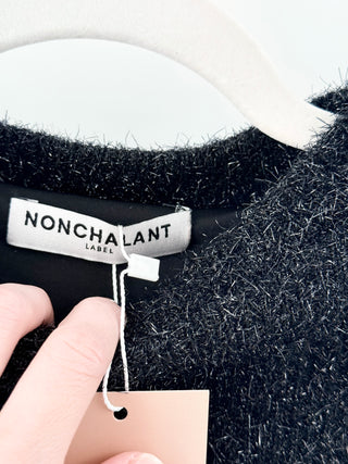 Nonchalant knit matching set featuring textured slightly shimmering boucle-style fabric. Includes cropped sweater paired with coordinating mini skirt, S