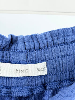 Mango two-piece set crafted from lightweight textured cotton featuring button-down long sleeve top with soft collar and tie-front detail paired with matching high-waisted pants, S