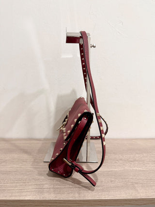 Valentino Garavani Pebbled Calfskin Medium Rockstud Flip Lock Crossbody Bag burgundy