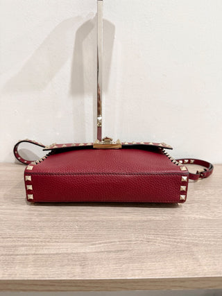 Valentino Garavani Pebbled Calfskin Medium Rockstud Flip Lock Crossbody Bag burgundy