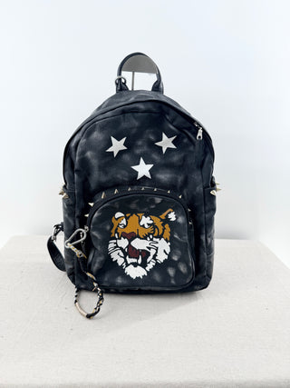 queen b faux leather mini backpack featuring bold tiger graphic on front pocket and stud detailing, designed with top handle, adjustable shoulder straps