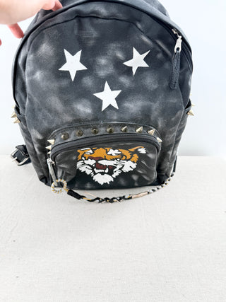 queen b faux leather mini backpack featuring bold tiger graphic on front pocket and stud detailing, designed with top handle, adjustable shoulder straps