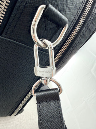 Louis Vuitton briefcase crafted in signature taiga leather featuring top zip closure, front slip pocket, and rolled leather handles