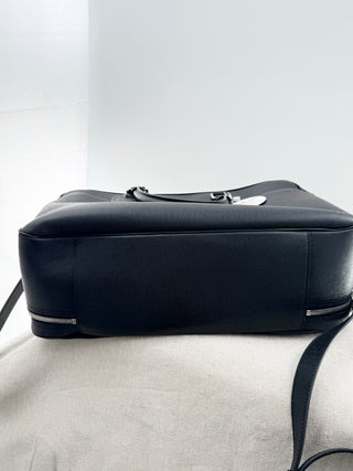 Louis Vuitton briefcase crafted in signature taiga leather featuring top zip closure, front slip pocket, and rolled leather handles