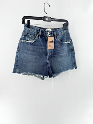 Agolde high-rise denim shorts featuring vintage wash, distressed detailing, and frayed raw hem, 27